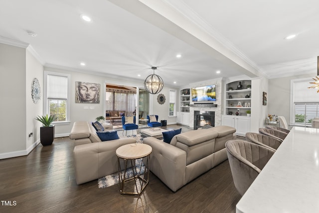 7741 Wilderness Rd, Raleigh, NC 27613 - living area with a chandelier, recessed lighting, ornamental molding, healthy amount of natural light, and a fireplace