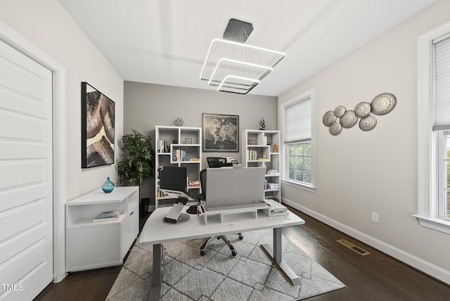 7741 Wilderness Rd, Raleigh, NC 27613 - home office featuring dark wood-style floors and a chandelier