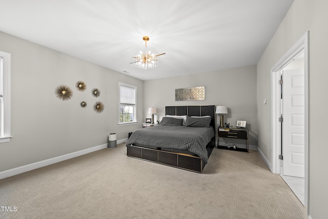 7741 Wilderness Rd, Raleigh, NC 27613 - carpeted bedroom featuring a chandelier and baseboards