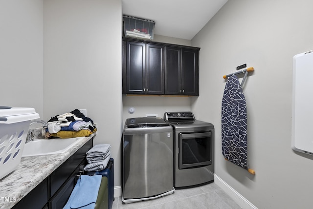 7741 Wilderness Rd, Raleigh, NC 27613 - washroom with cabinet space, independent washer and dryer, and light tile patterned floors