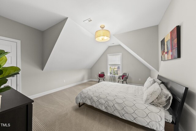 7741 Wilderness Rd, Raleigh, NC 27613 - carpeted bedroom with lofted ceiling and baseboards