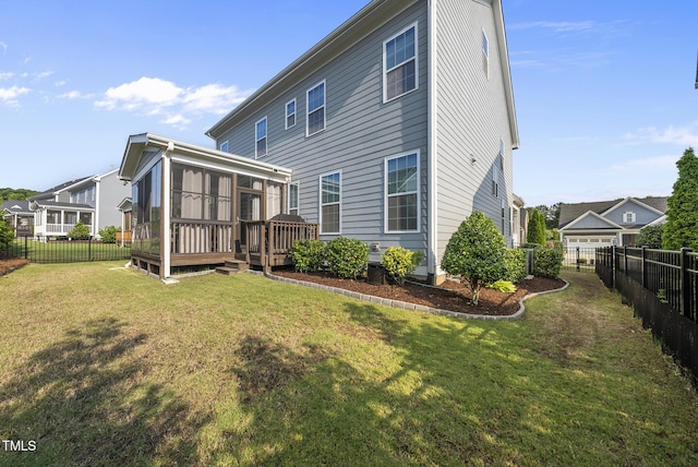 7741 Wilderness Rd, Raleigh, NC 27613 - back of house featuring a sunroom, a fenced backyard, and a deck
