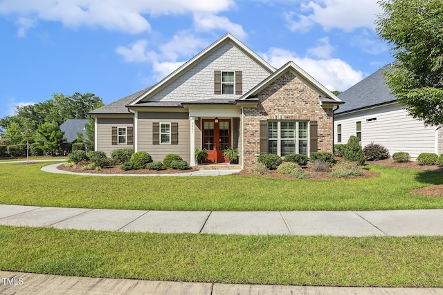 2461 Patriot Bluffs Dr, Fuquay Varina, NC 27526 - craftsman house featuring a front lawn, brick siding, and french doors