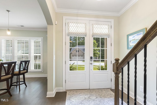 2461 Patriot Bluffs Dr, Fuquay Varina, NC 27526 - foyer entrance with plenty of natural light, arched walkways, crown molding, and dark wood-style flooring