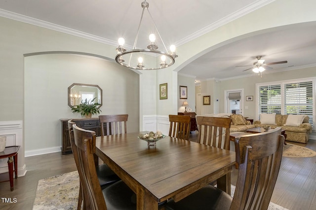 2461 Patriot Bluffs Dr, Fuquay Varina, NC 27526 - dining area with arched walkways, ceiling fan, wood finished floors, crown molding, and a chandelier