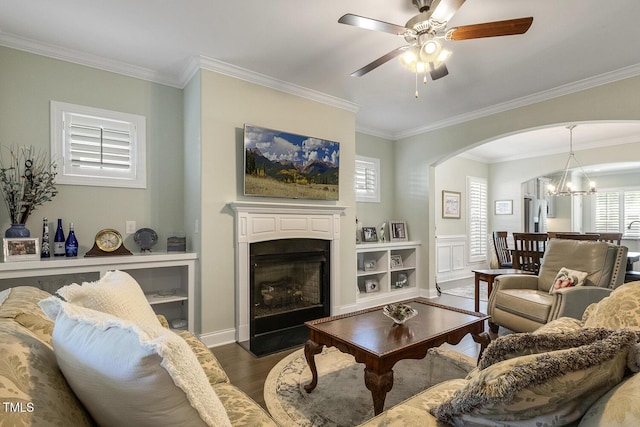 2461 Patriot Bluffs Dr, Fuquay Varina, NC 27526 - living room featuring crown molding, arched walkways, wood finished floors, a fireplace with flush hearth, and ceiling fan