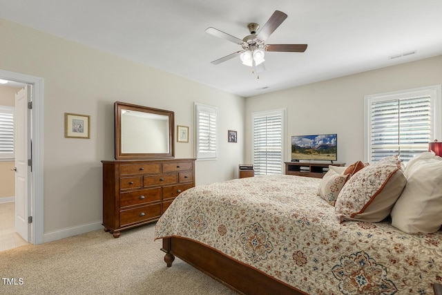 2461 Patriot Bluffs Dr, Fuquay Varina, NC 27526 - bedroom with multiple windows, light carpet, and ceiling fan