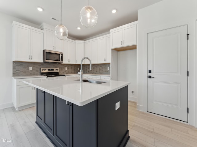 812 Barlow Dr Unit 255, Knightdale, NC 27545 - kitchen with stainless steel microwave, white cabinets, range with electric cooktop, tasteful backsplash, and recessed lighting