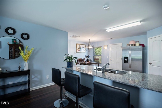 443 Waterfall Rd, Henderson, NC 27537 - kitchen with stainless steel refrigerator with ice dispenser, dark wood-style floors, stone countertops, a chandelier, and pendant lighting