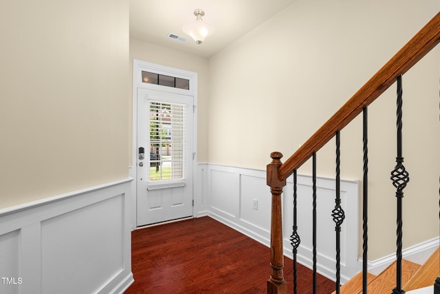 508 Durants Neck Ln, Morrisville, NC 27560 - foyer entrance featuring dark wood-style flooring, a wainscoted wall, stairs, and a decorative wall