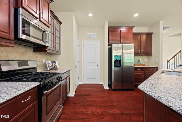 508 Durants Neck Ln, Morrisville, NC 27560 - kitchen featuring stainless steel appliances, dark wood-type flooring, light stone countertops, backsplash, and recessed lighting
