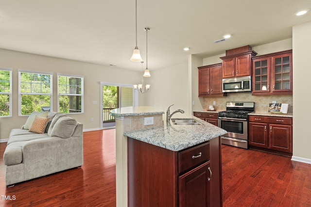 508 Durants Neck Ln, Morrisville, NC 27560 - kitchen featuring stainless steel appliances, open floor plan, tasteful backsplash, dark wood-style floors, and glass insert cabinets