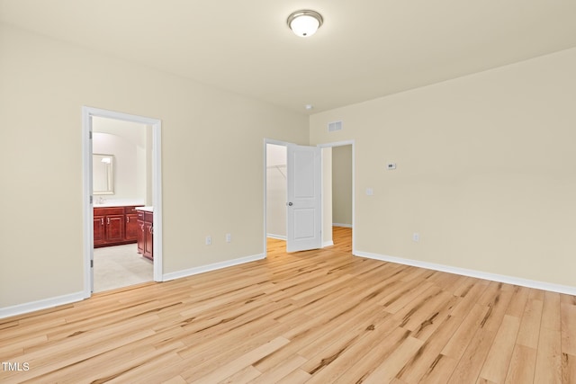 508 Durants Neck Ln, Morrisville, NC 27560 - unfurnished bedroom with light wood-style flooring, a walk in closet, and ensuite bath