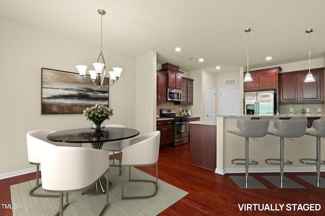 508 Durants Neck Ln, Morrisville, NC 27560 - dining space featuring dark wood finished floors, a chandelier, and recessed lighting