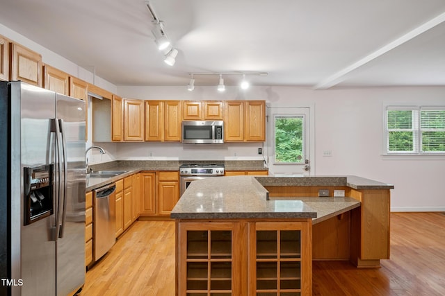 9903 Oak Hollow Rd, Chapel Hill, NC 27516 - kitchen featuring appliances with stainless steel finishes, light wood finished floors, track lighting, and healthy amount of natural light