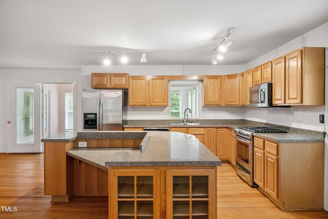 9903 Oak Hollow Rd, Chapel Hill, NC 27516 - kitchen featuring stainless steel appliances, a kitchen island, track lighting, and light wood-style flooring
