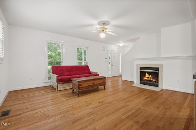 9903 Oak Hollow Rd, Chapel Hill, NC 27516 - living room featuring light wood-style floors, a warm lit fireplace, and ceiling fan