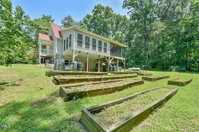 9903 Oak Hollow Rd, Chapel Hill, NC 27516 - back of house with a garden, a sunroom, and a yard