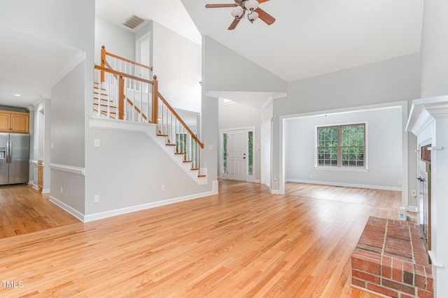 106 Windstream Way, Cary, NC 27518 - unfurnished living room featuring stairs, ceiling fan, light wood finished floors, and high vaulted ceiling