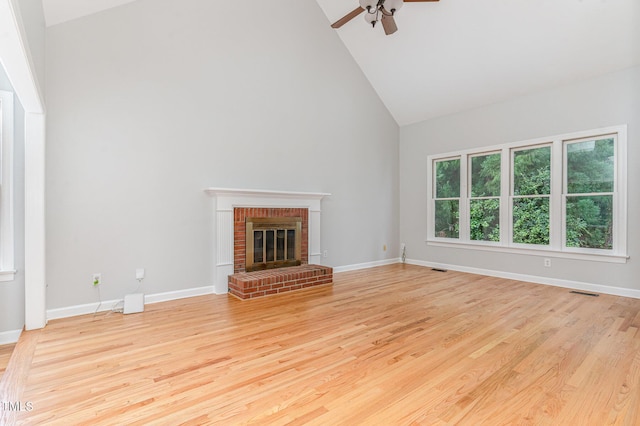 106 Windstream Way, Cary, NC 27518 - unfurnished living room with high vaulted ceiling, ceiling fan, light wood-style floors, and a brick fireplace