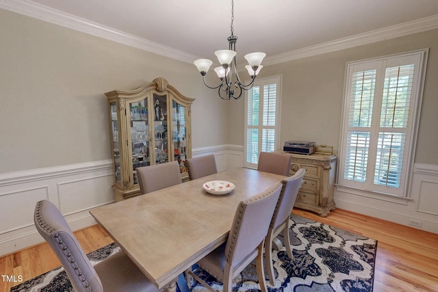 4 Springtree Cir, Durham, NC 27712 - dining area with a chandelier, ornamental molding, light wood-style floors, wainscoting, and a decorative wall