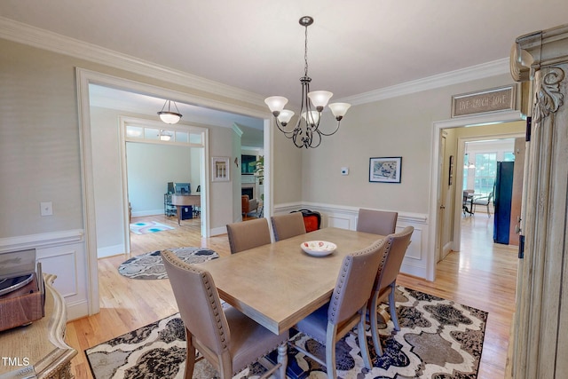4 Springtree Cir, Durham, NC 27712 - dining room featuring ornamental molding, light wood finished floors, a wainscoted wall, and a chandelier