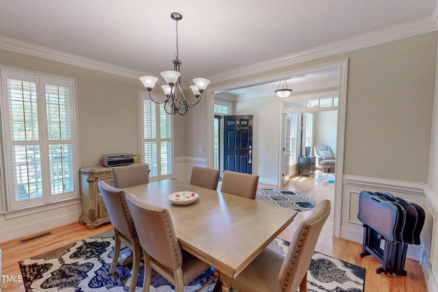4 Springtree Cir, Durham, NC 27712 - dining room with a chandelier, light wood-style floors, and crown molding