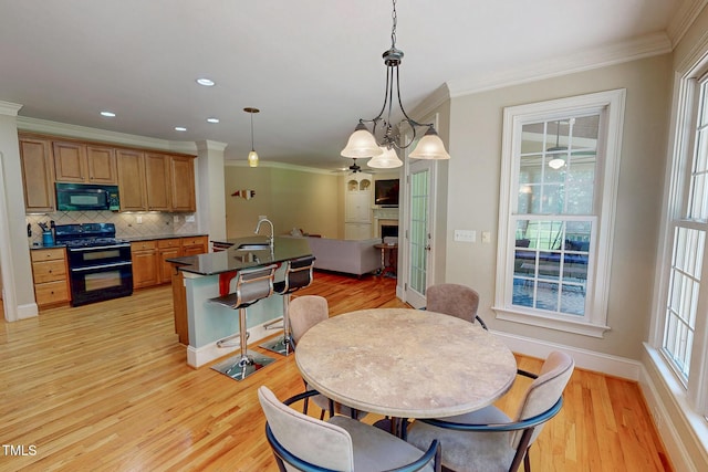 4 Springtree Cir, Durham, NC 27712 - dining space featuring crown molding, light wood-type flooring, a chandelier, and recessed lighting