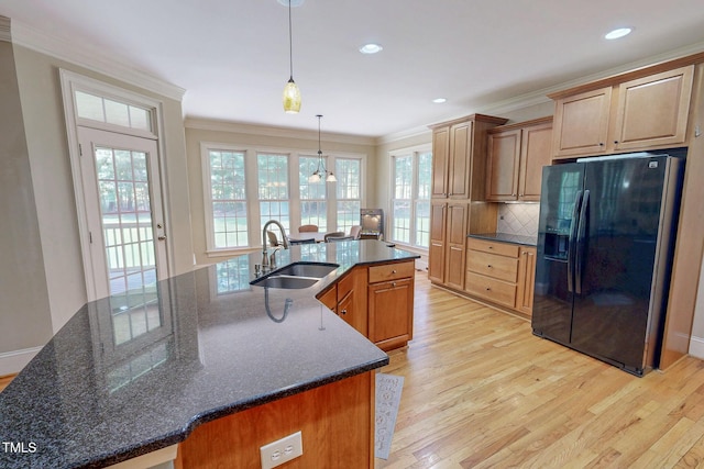 4 Springtree Cir, Durham, NC 27712 - kitchen with black refrigerator with ice dispenser, ornamental molding, light wood-type flooring, tasteful backsplash, and a spacious island