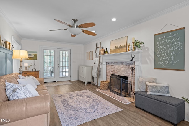 1604 Farm Lake Dr, Holly Springs, NC 27540 - living area featuring wood finished floors, a ceiling fan, ornamental molding, a fireplace, and recessed lighting