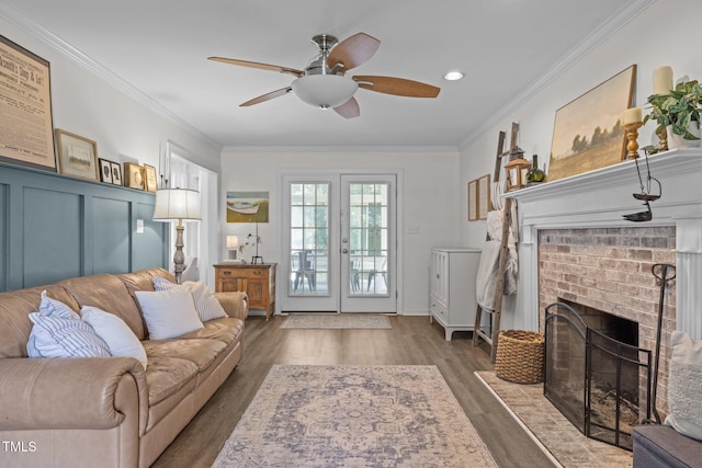 1604 Farm Lake Dr, Holly Springs, NC 27540 - living area with a brick fireplace, a ceiling fan, ornamental molding, and wood finished floors