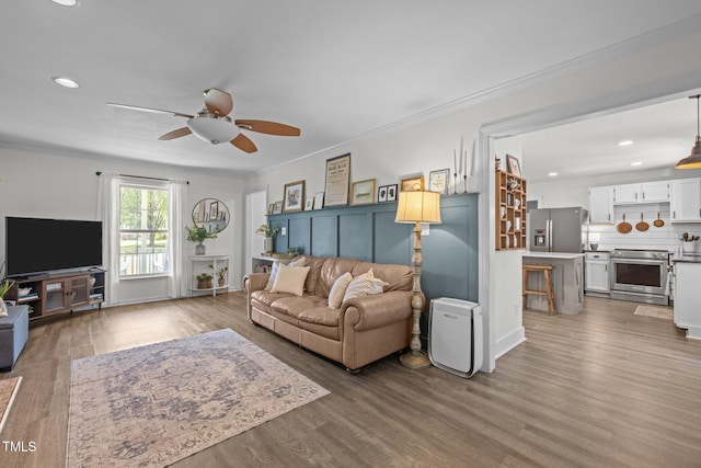 1604 Farm Lake Dr, Holly Springs, NC 27540 - living area featuring a ceiling fan, wood finished floors, recessed lighting, and crown molding
