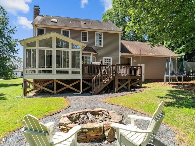 1604 Farm Lake Dr, Holly Springs, NC 27540 - back of house featuring a fire pit, a sunroom, a trampoline, a chimney, and a deck