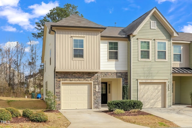 1301 Garden Stone Dr, Raleigh, NC 27610 - view of front of house featuring a garage, driveway, stone siding, and board and batten siding