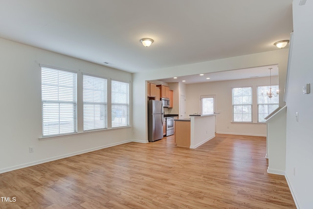 1301 Garden Stone Dr, Raleigh, NC 27610 - kitchen with stainless steel appliances, open floor plan, a chandelier, plenty of natural light, and recessed lighting