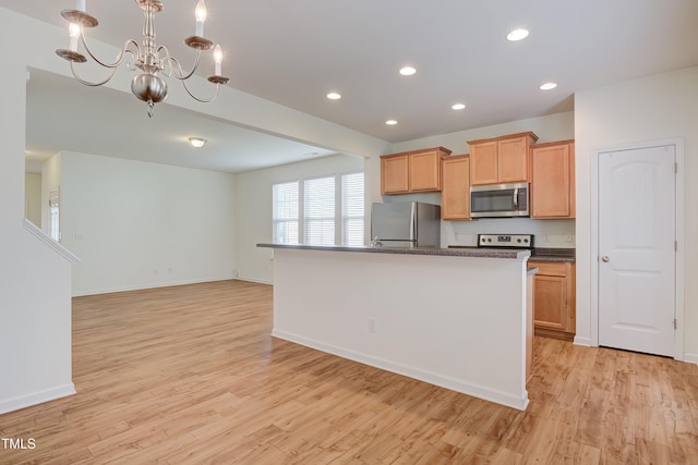 1301 Garden Stone Dr, Raleigh, NC 27610 - kitchen with appliances with stainless steel finishes, dark countertops, a chandelier, light wood-type flooring, and recessed lighting