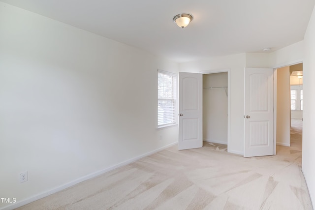 1301 Garden Stone Dr, Raleigh, NC 27610 - unfurnished bedroom featuring light carpet, multiple windows, and a closet