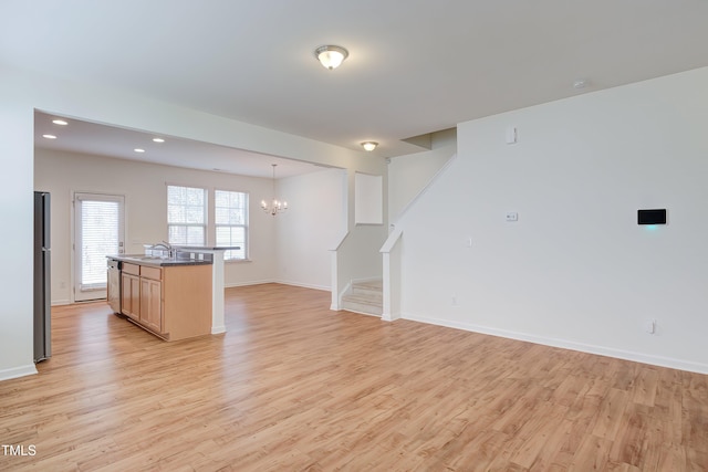 1301 Garden Stone Dr, Raleigh, NC 27610 - kitchen with light wood-style flooring, a chandelier, freestanding refrigerator, open floor plan, and recessed lighting