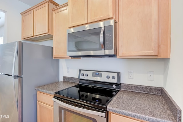 1301 Garden Stone Dr, Raleigh, NC 27610 - kitchen with appliances with stainless steel finishes, light brown cabinetry, and dark countertops