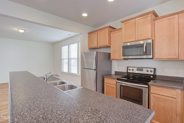 1301 Garden Stone Dr, Raleigh, NC 27610 - kitchen with appliances with stainless steel finishes, dark countertops, light brown cabinetry, recessed lighting, and light wood-style flooring