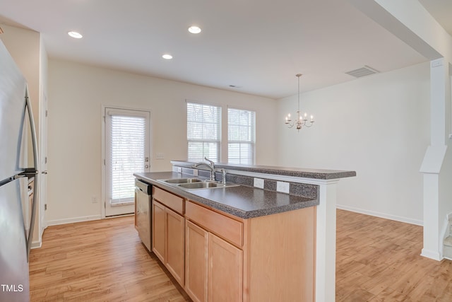1301 Garden Stone Dr, Raleigh, NC 27610 - kitchen featuring light brown cabinets, appliances with stainless steel finishes, dark countertops, light wood finished floors, and recessed lighting