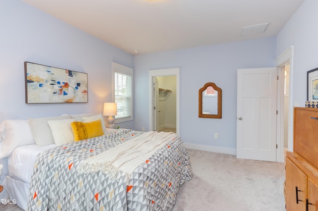 119 W Piedmont Ave, Durham, NC 27707 - bedroom with light carpet, a walk in closet, and attic access
