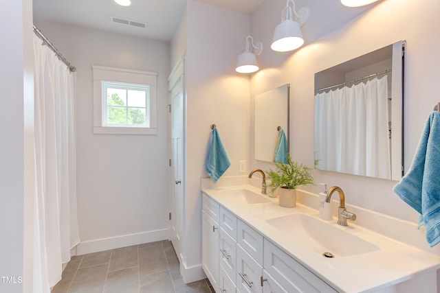 119 W Piedmont Ave, Durham, NC 27707 - full bathroom with double vanity and tile patterned flooring