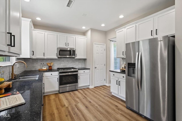 5 Bent Branch Ct, Durham, NC 27704 - kitchen with stainless steel appliances, light wood-style floors, white cabinetry, recessed lighting, and backsplash