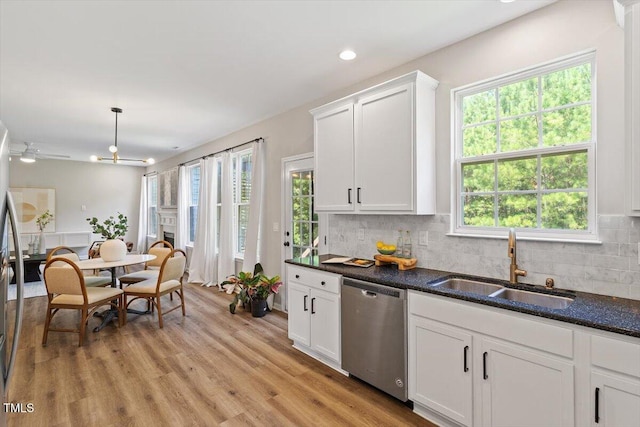 5 Bent Branch Ct, Durham, NC 27704 - kitchen with stainless steel dishwasher, white cabinets, backsplash, light wood-type flooring, and recessed lighting