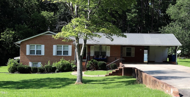 311 Ebon Rd, Durham, NC 27713 - single story home featuring concrete driveway, brick siding, an attached carport, and a front lawn