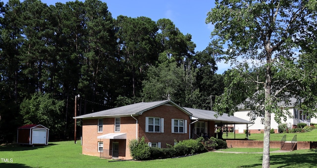 311 Ebon Rd, Durham, NC 27713 - view of front of property featuring a front lawn, brick siding, and a shed