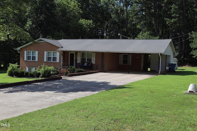 311 Ebon Rd, Durham, NC 27713 - single story home with concrete driveway, brick siding, a front lawn, and covered porch