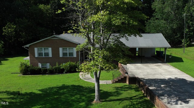 311 Ebon Rd, Durham, NC 27713 - view of front of property with concrete driveway, brick siding, a front lawn, and a carport