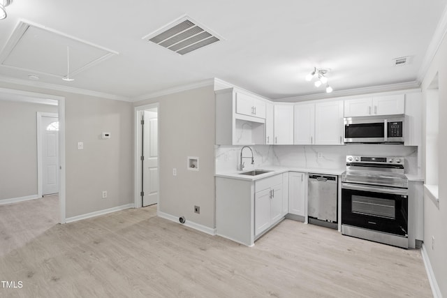 2705 Crest St Unit 3, Durham, NC 27705 - kitchen featuring appliances with stainless steel finishes, ornamental molding, light wood finished floors, light countertops, and white cabinetry